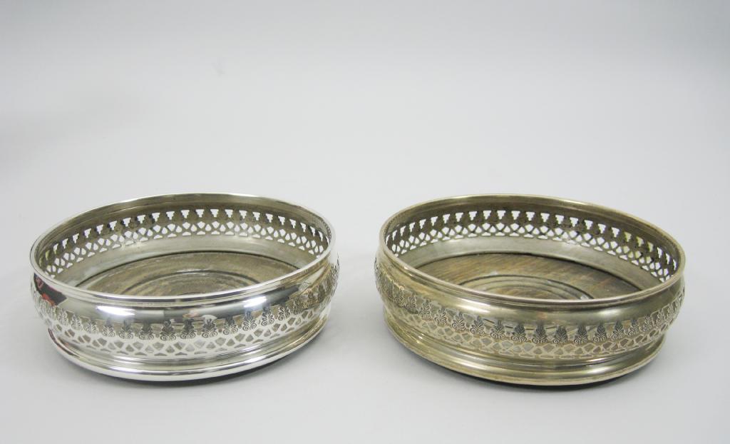 Appraisal: Pair of modern silver pierced circular Coasters with turned wooden