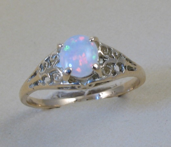 Appraisal: OPAL AND FOURTEEN KARAT GOLD RING centered and prong set