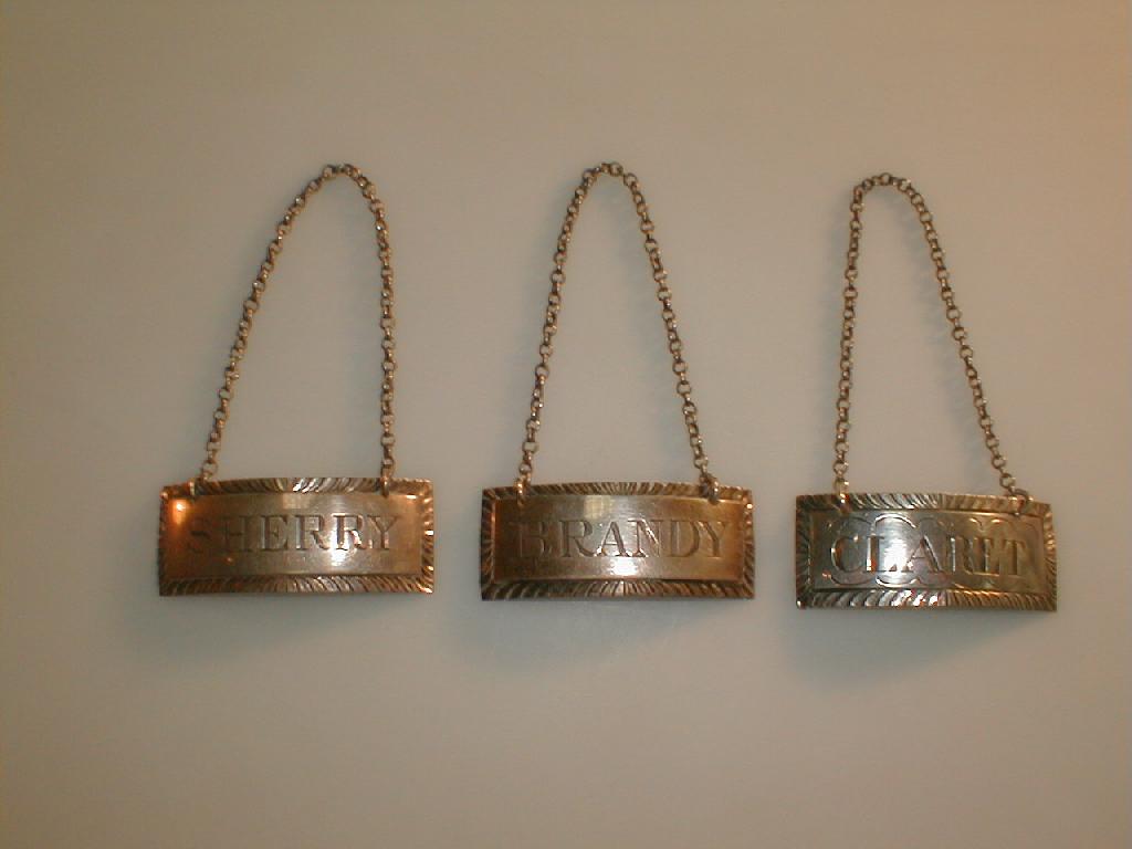 Appraisal: A set of three silver decanter labels of oblong form