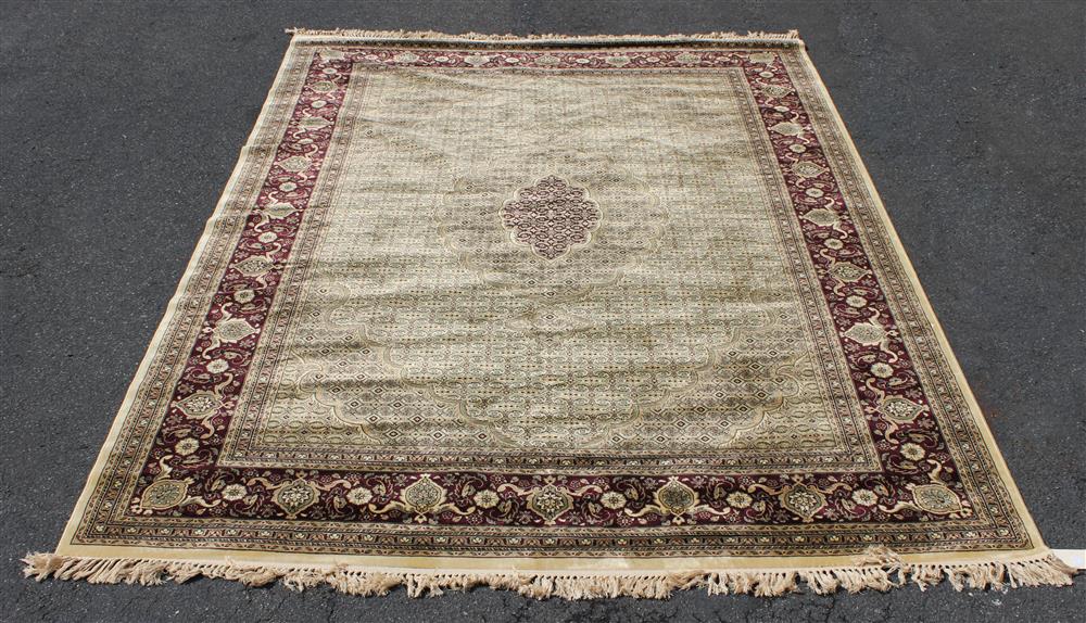 Appraisal: MACHINE MADE ORIENTAL DESIGN WOOL RUG colors include burgundy sage