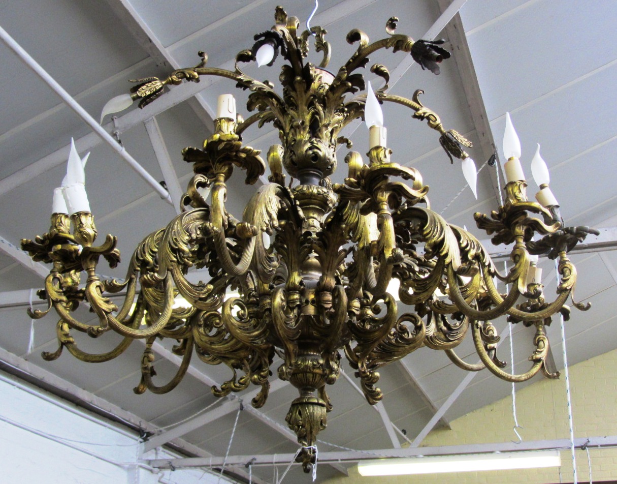 Appraisal: An eighteen light gilt bronze chandelier of scrollwork rococo design