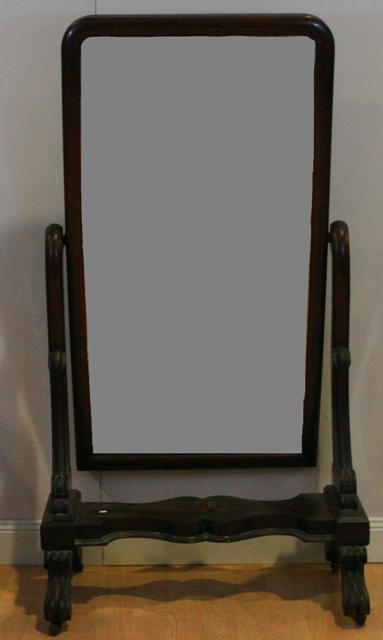 Appraisal: A Victorian mahogany cheval mirror with serpentine scroll reeded legs