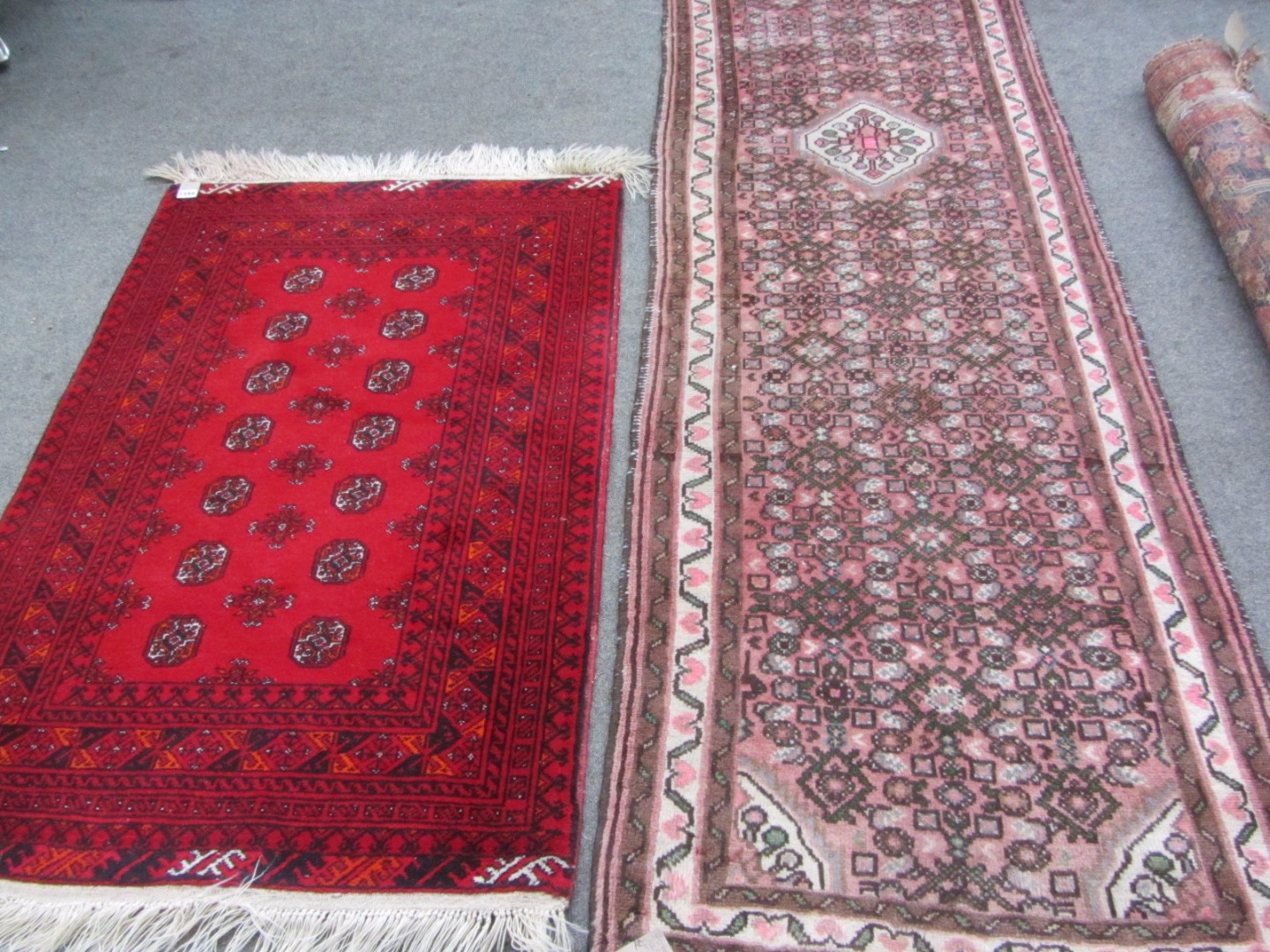 Appraisal: An Afghan rug the madder field with two columns of