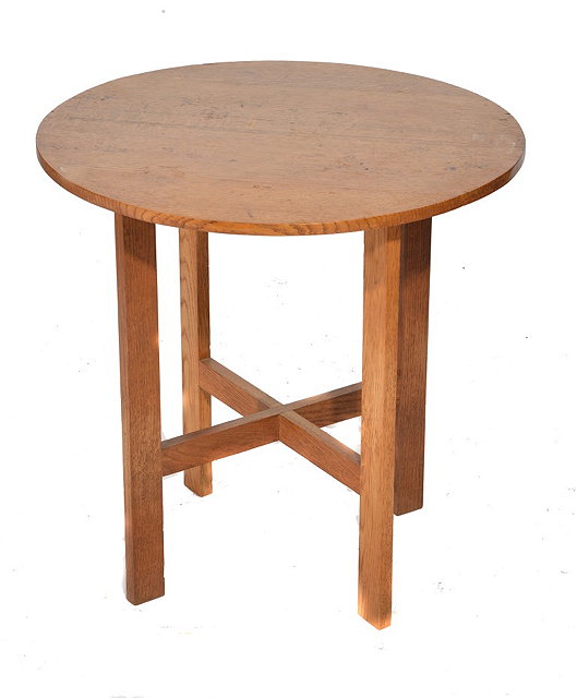 Appraisal: A COTSWOLD SCHOOL LIGHT OAK CIRCULAR OCCASIONAL TABLE 'X' frame