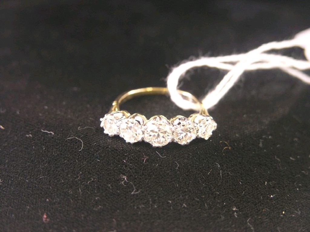 Appraisal: A gold five stone diamond half-hoop ring principal stone approximately