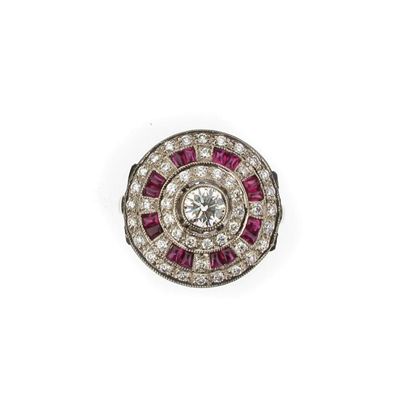 Appraisal: A circular diamond and ruby ring The circular cut diamonds