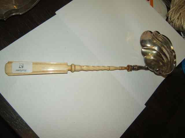 Appraisal: A CONTINENTAL WHITE METAL AND IVORY PUNCH LADLE the shell