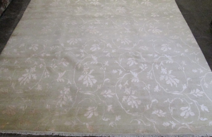 Appraisal: HAND KNOTTED ORIENTAL CARPET featuring white floral tracery on borderless