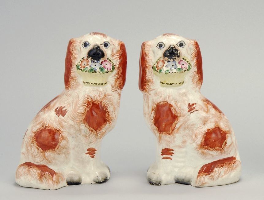 Appraisal: RARE PAIR OF STAFFORDSHIRE SPANIELS WITH FLOWER BASKETS Circa In