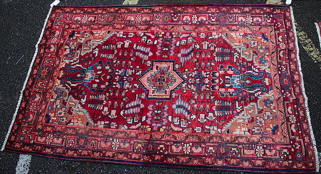 Appraisal: A HAMADAN RED GROUND RUG with floral decoration to the