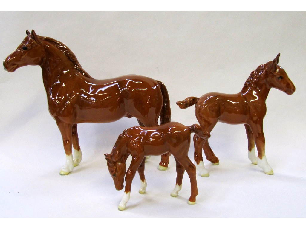 Appraisal: Three Beswick chestnut horses to include foal model no foal