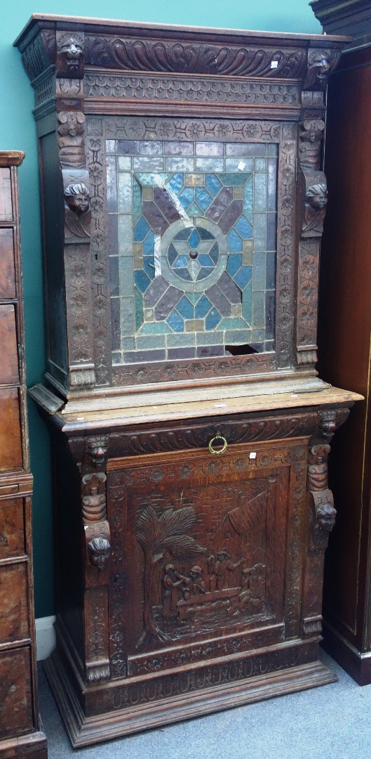 Appraisal: A th century carved oak double height adjustable cupboard with