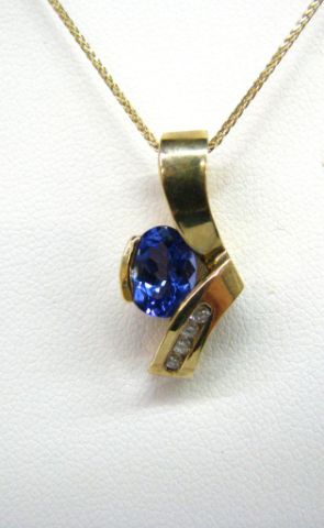 Appraisal: Contemporary-styled tanzanite and diamond K yellow gold pendant on K