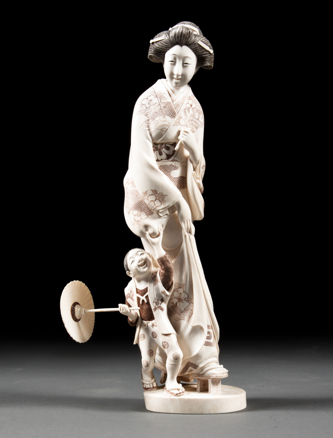 Appraisal: Japanese carved ivory mother and child modeled as traditional Japanese