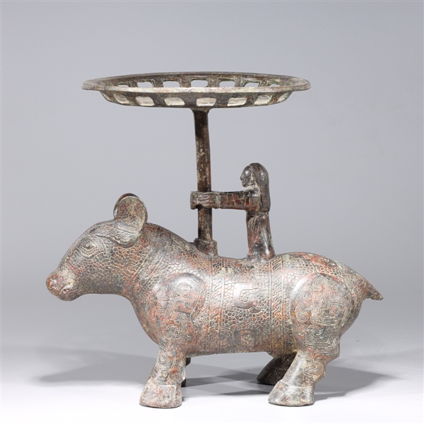 Appraisal: Chinese archaistic bronze animal-form candle stick with figure riding animal