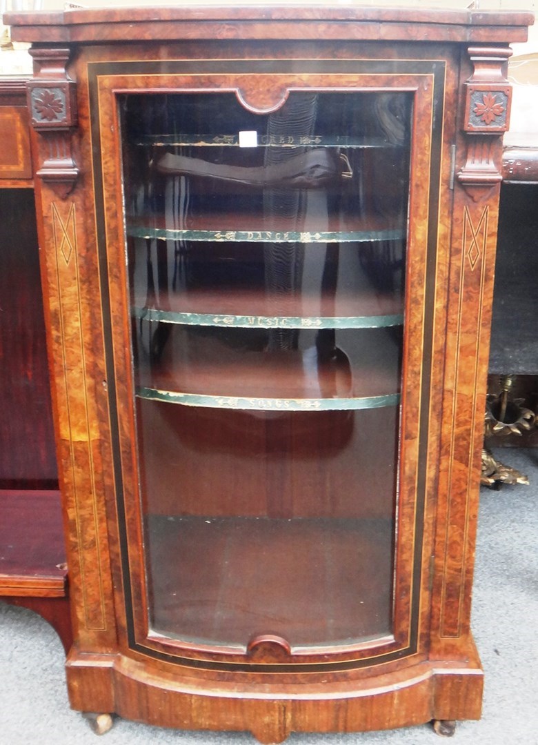 Appraisal: A Victorian figured walnut glazed bowfront music cabinet cm wide