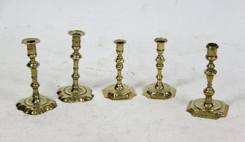 Appraisal: A pair of th Century brass petal based candlesticks another