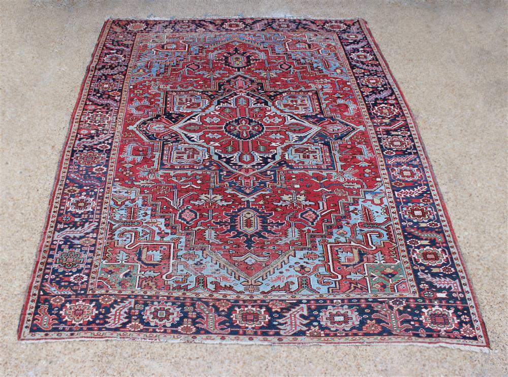 Appraisal: ANTIQUE HERIZ WOOL RUG colors include rose reds blues ivory