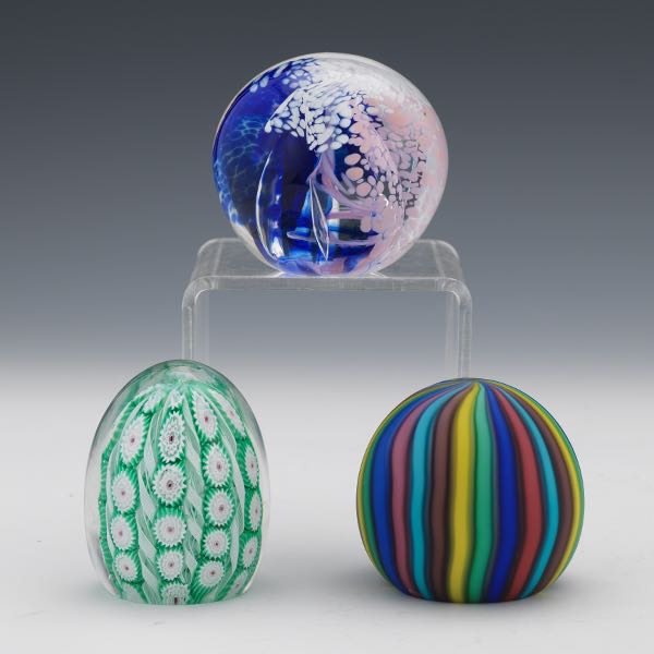 Appraisal: THREE PAPERWEIGHTS One millefiori one swirled glass one clear with