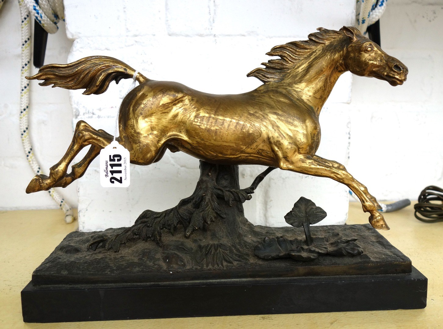 Appraisal: A gilt bronze model of a galloping stallion late th