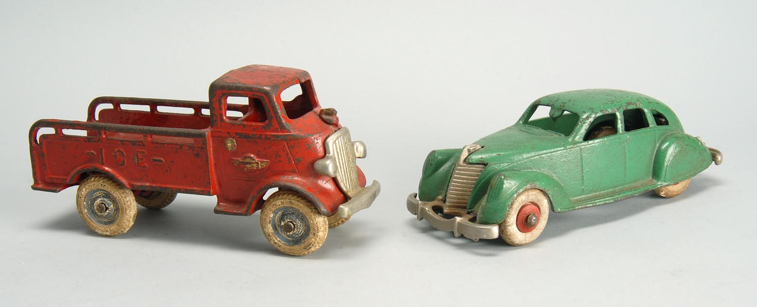 Appraisal: TWO CIRCA 'S CAST IRON TOY VEHICLES a car in