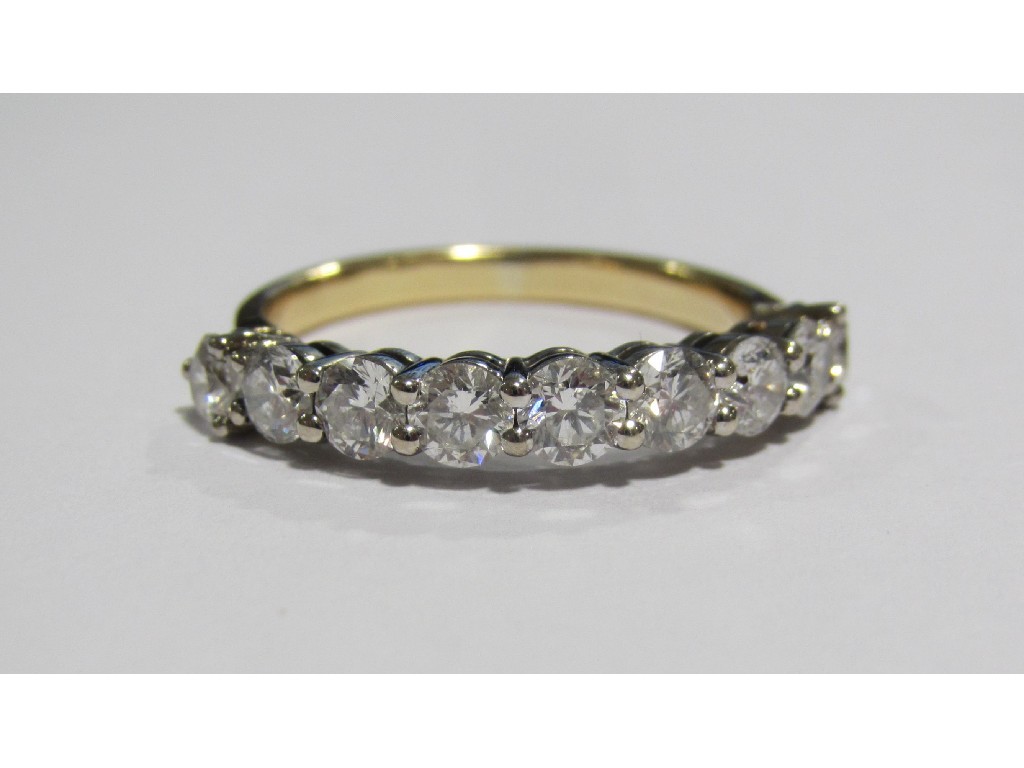 Appraisal: An eighteen carat bi colour gold diamond nine stone half