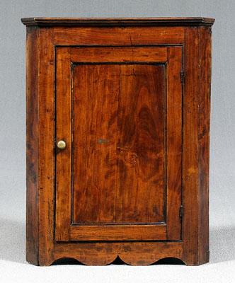 Appraisal: Georgian hanging corner cupboard mahogany with molded cornice single panel