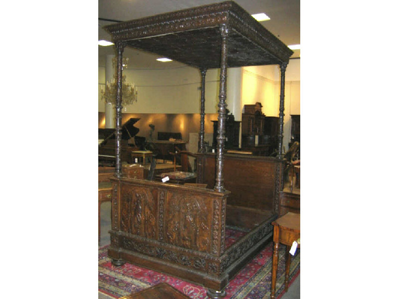 Appraisal: CONTINENTAL OAK AND LEATHER CANOPY BED Having a foliate and