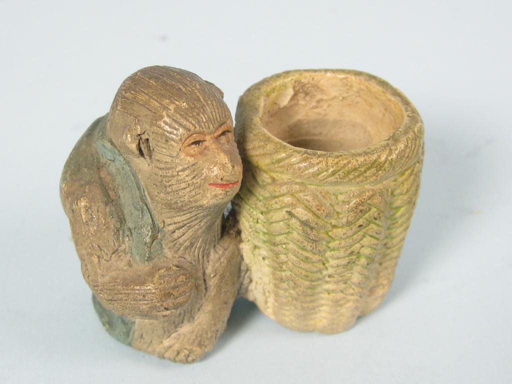 Appraisal: A Japanese pottery Figure of a monkey crouching by a