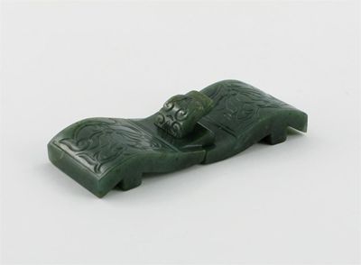 Appraisal: A Chinese spinach-jade belt buckle each piece carved with a