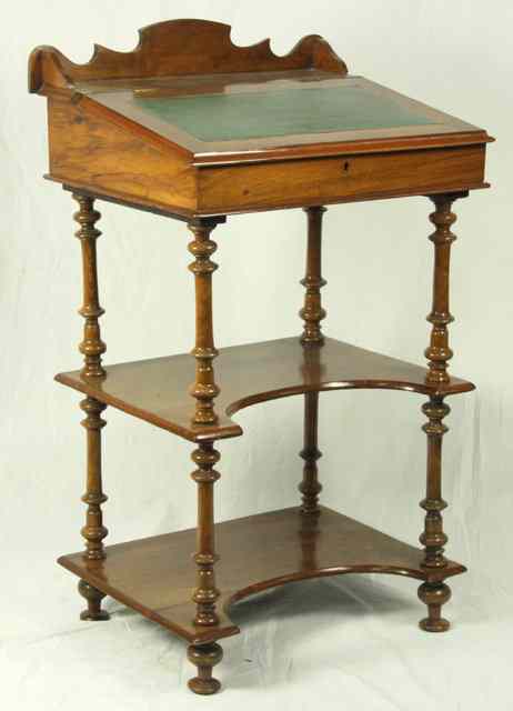 Appraisal: An Edwardian Davenport desk with writing slope above two platforms