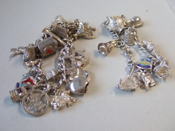 Appraisal: Two charm bracelets fitted with mostly silver charms including enameled