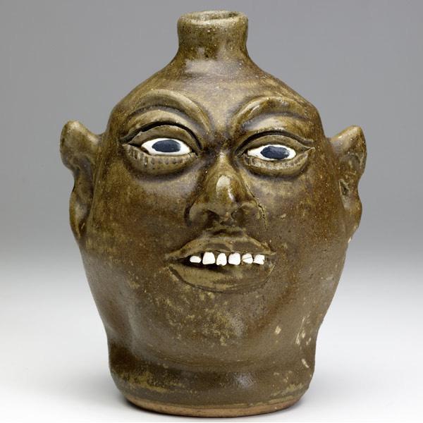 Appraisal: LANIER MEADERS Folk Art face jug with smiling expression and