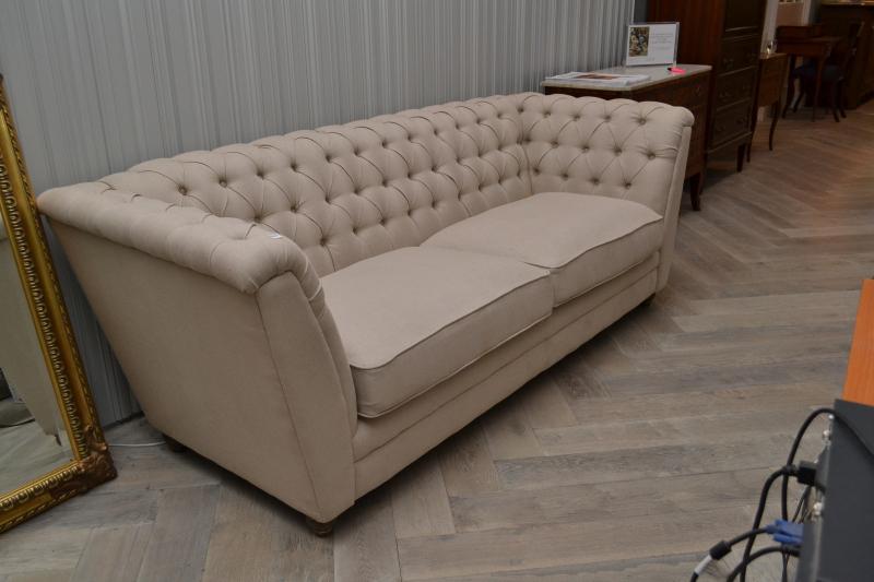 Appraisal: A CONTEMPORARY THREE SEAT BUTTONBACK SOFA IN NATURAL LINEN UPHOLSTERY