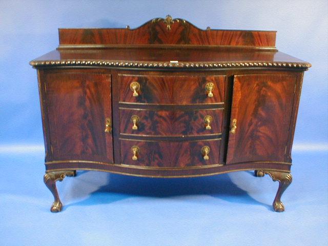 Appraisal: A 's flamed mahogany Serpentine sideboard with gadrooned top and