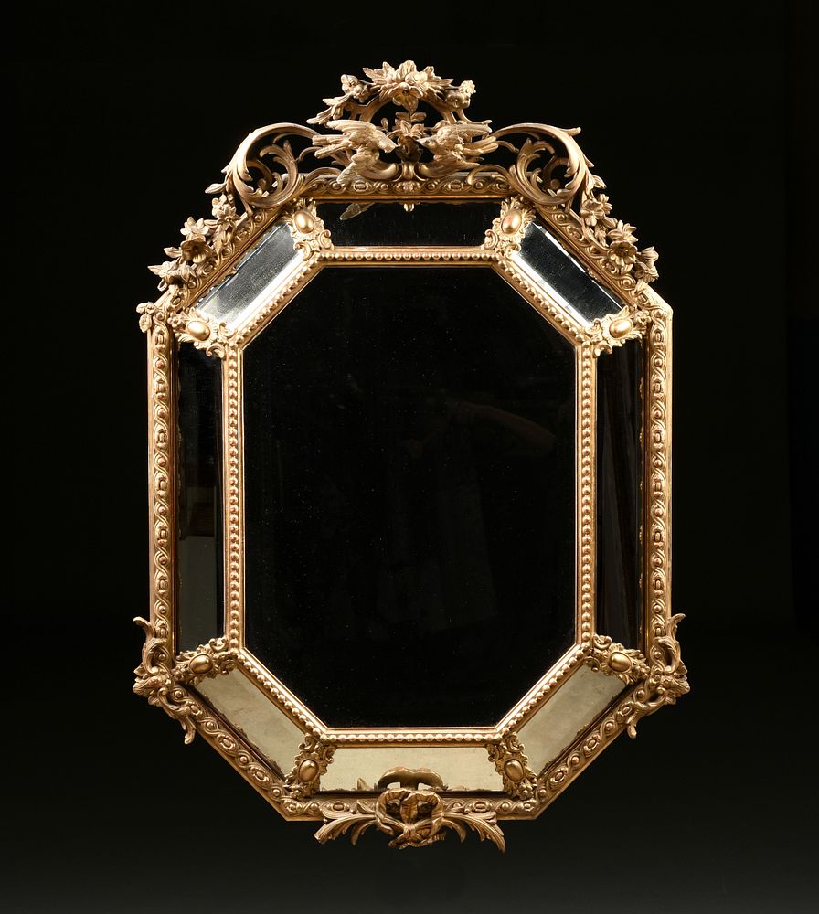 Appraisal: A REGENCE STYLE PARCEL GILT AND CARVED WOOD OCTAGONAL MIRROR