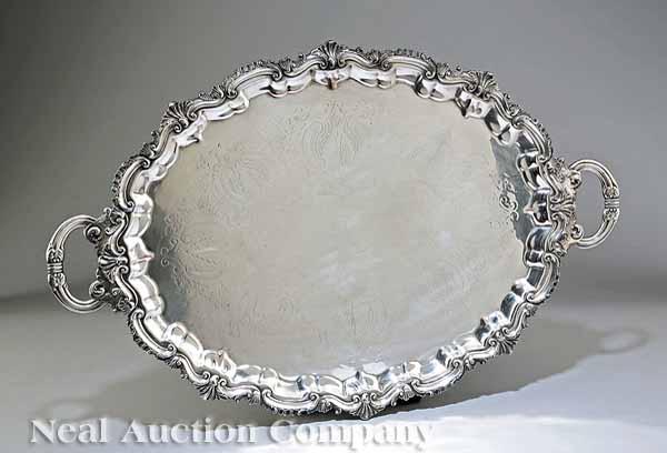 Appraisal: An Antique Silverplate Serving Tray with foliate scroll rim reeded