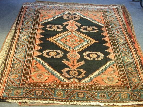 Appraisal: A HAMADAN BLUE GROUND RUG decorated a central medallion within