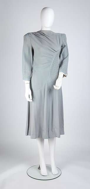 Appraisal: A mid- s pale blue crepe dress with asymmetric curved