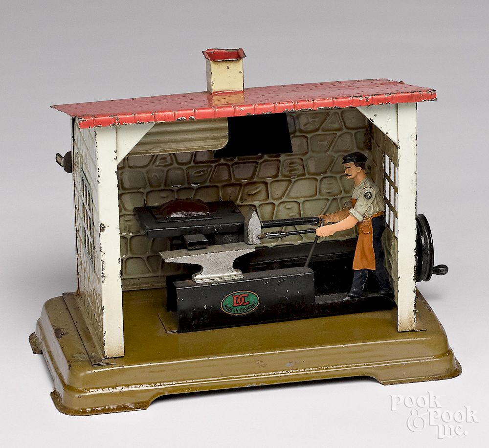 Appraisal: Blacksmith shop steam toy accessory Doll painted tin blacksmith shop