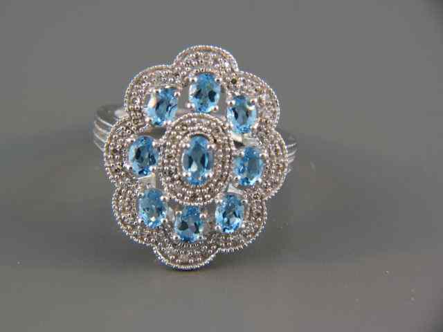 Appraisal: Blue Topaz Diamond Ring vivid oval gems surrounded by diamonds