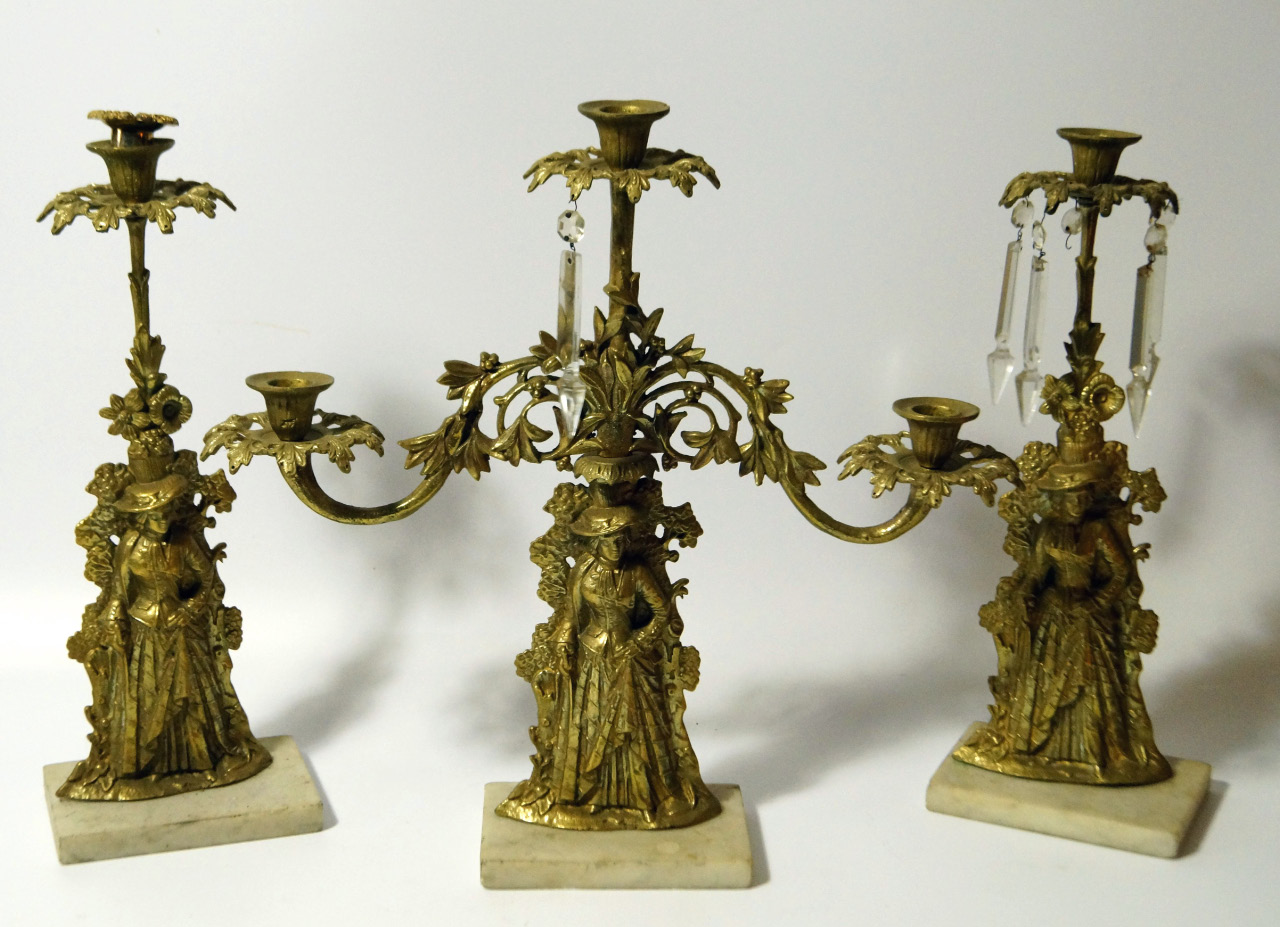 Appraisal: A Victorian garniture of gilt brass candlesticks each cast with