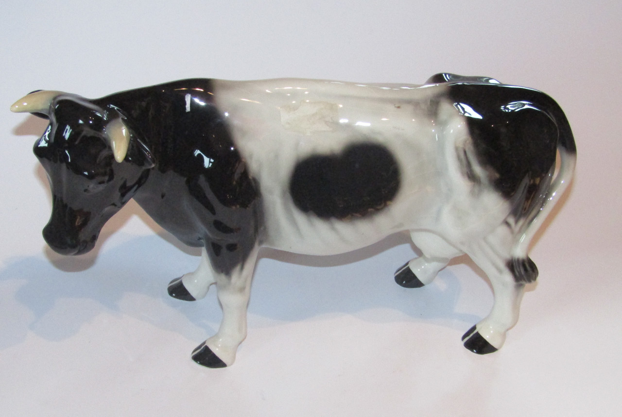 Appraisal: A thC pottery figure of a standing Friesian cow in