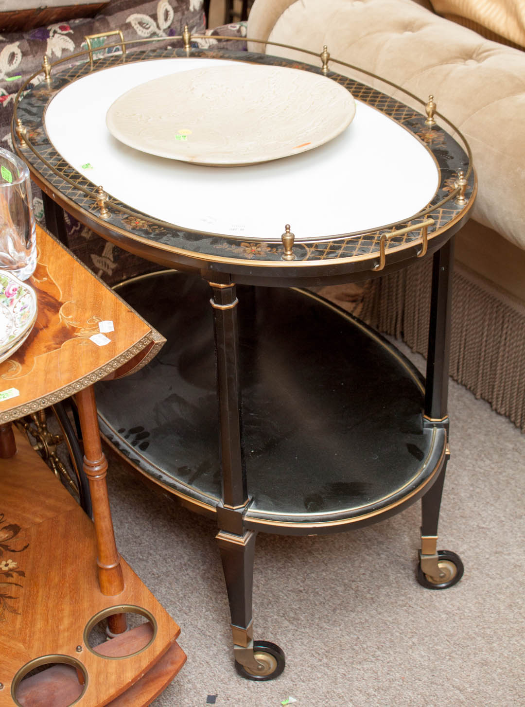 Appraisal: Glass top two tiered tea cart ebonized wood black ground