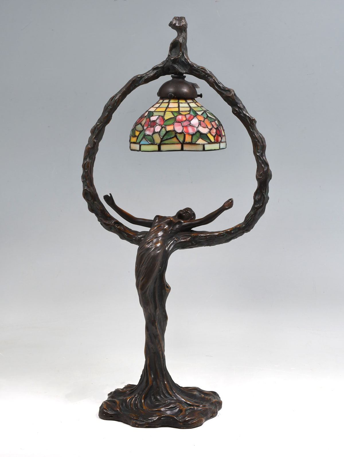 Appraisal: ART NOUVEAU STYLE FIGURAL TABLE LAMP '' h leaded glass