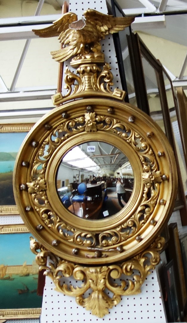 Appraisal: A th century gilt framed convex wall mirror with eagle