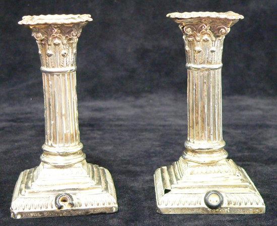 Appraisal: A pair of Corinthian column candlesticks with gadroon borders having