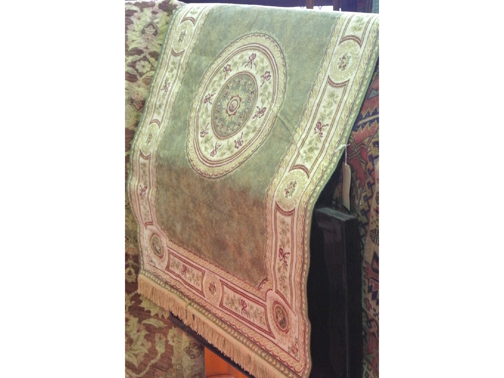 Appraisal: A machine woven rug with pale green field interspersed with