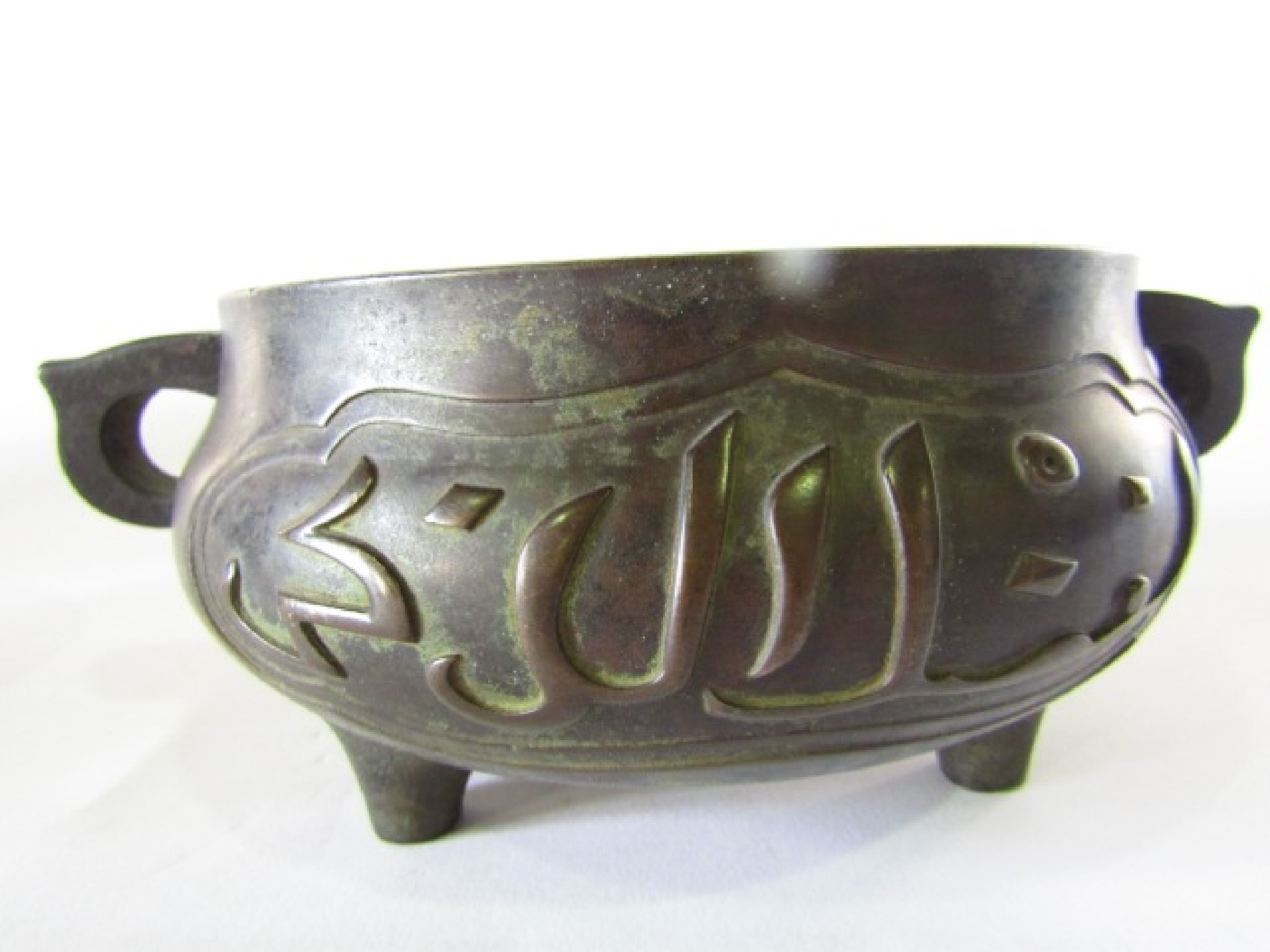 Appraisal: A heavy Chinese bronze two-handled oriental censer with relief decoration