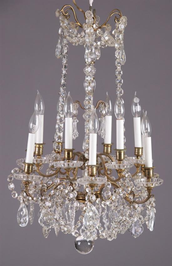 Appraisal: BRASS AND CRYSTAL TWELVE-LIGHT CHANDELIER Early th century Chain suspended